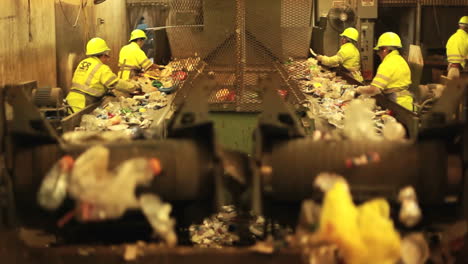 Excellent-shot-of-workers-in-a-recycling-center-sorting-trash-on-conveyor-belts-1