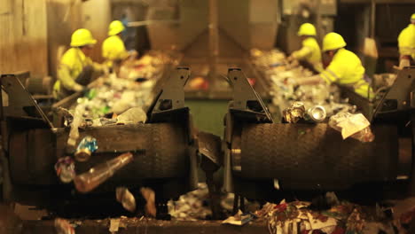 Excellent-shot-of-workers-in-a-recycling-center-sorting-trash-on-conveyor-belts-2