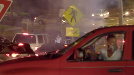 Cars-drive-through-Ferguson-Missouri-at-night-confronting-police