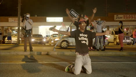 Protestors-fall-to-their-knees-to-oncoming-police-in-the-Ferguson-riots