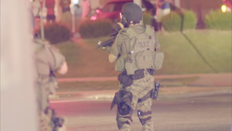 Police-with-automatic-weapons-patrol-the-streets-during-the-Ferguson-riots