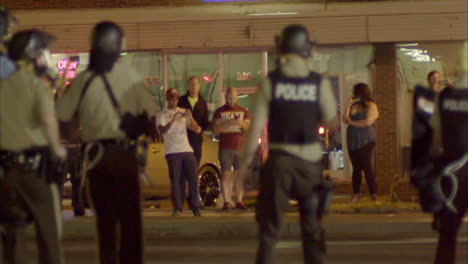 Police-with-automatic-weapons-patrol-the-streets-during-the-Ferguson-riots-1