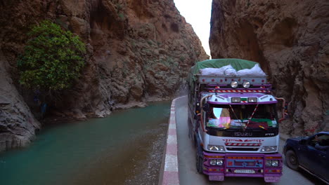 A-truck-travels-on-a-dangerous-winding-road-through-the-Atlas-Mountains-in-Morocco