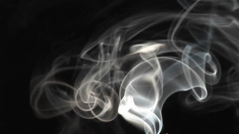 Closeup-of-incense-smoke-rising-against-a-black-background-1