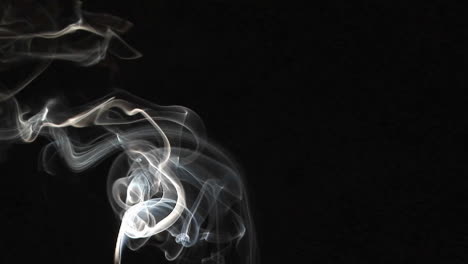Closeup-of-incense-smoke-rising-against-a-black-background-3