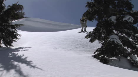 Mediumshot-of-a-snowboarder-snowboarding-downhill-across-virgin-powder