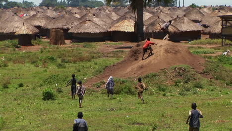 Longshot-of-young-children-run-and-playing-in-a-village-or-refugee-camp-in-Northern-Uganda