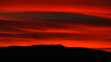 A-brilliant-red-sky-glows-above-a-rolling-mountain